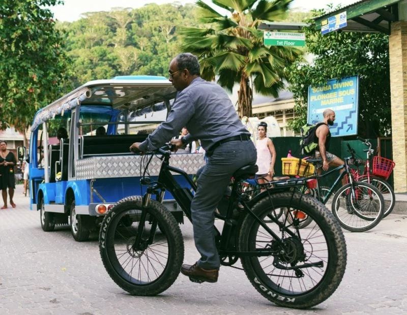 Adult man riding an e-bike in the city